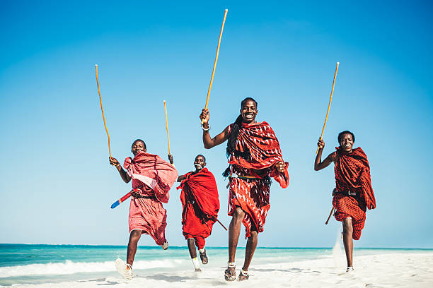 Masai People Running On The Beach.jpg Masai warriors running on beautiful african beach, demonstrating their traditional hunting methods (zanzibar, Tanzania), african tribal culture photos stock pictures, royalty-free photos & images