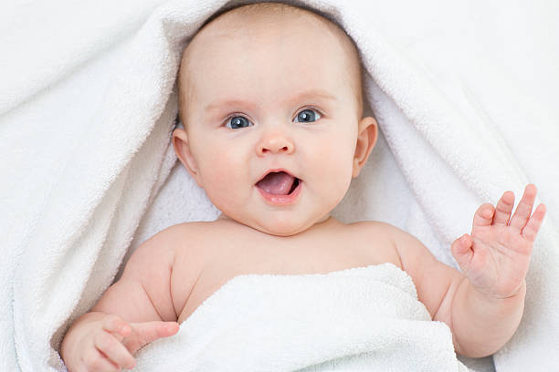 istock Cute smiling baby portrait lying on bathing towel 501917184