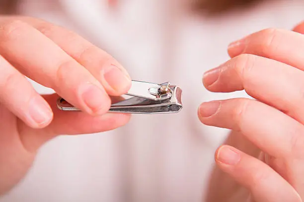 Photo of Cutting nails using nail clipper