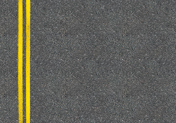 istock Asphalt road top view with two yellow lines 501918524