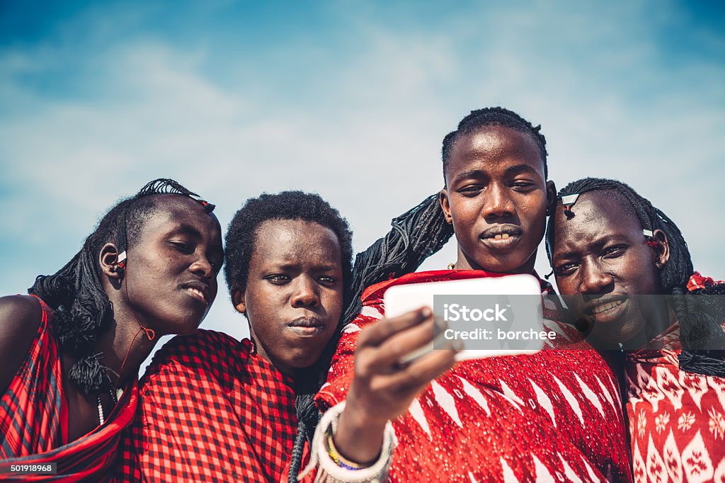 Masai Taking A Selfie Group of Masai warriors in traditional clothing taking a selfie with smart phone (Zanzibar, Africa). Africa Stock Photo