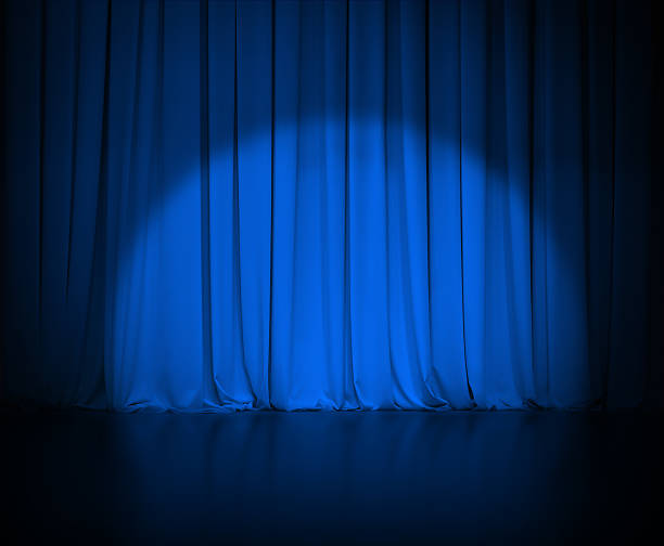 istock theatre dark blue curtain or drapes with light spot 501918982