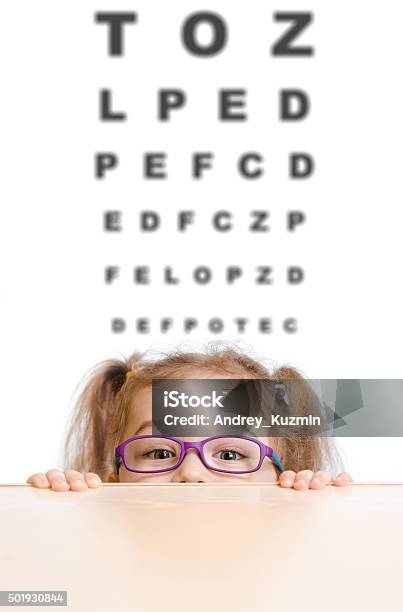 Funny Girl In Eyeglasses With Eye Chart Stock Photo - Download Image Now - Chart, Child, Optometry