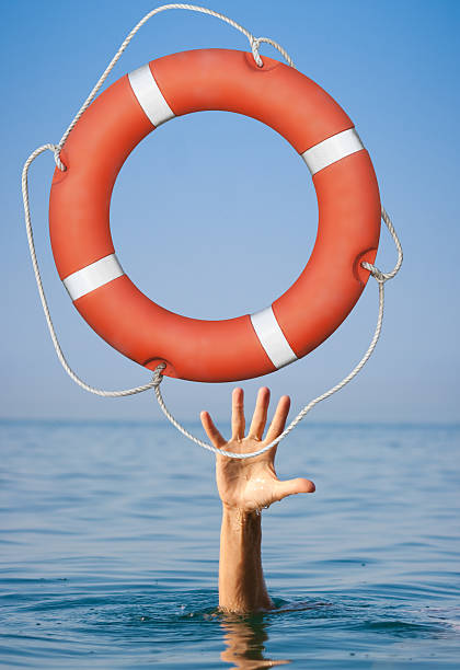 istock Help concept. Lifebuoy for drowning man's hand in open 501931220