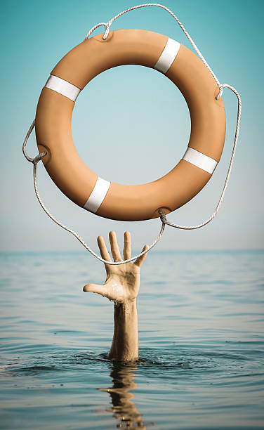 istock Hand in sea water with lifebuoy asking for help 501931262