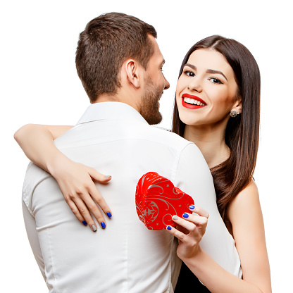 Hip young couple holding hands against red heart balloons floating