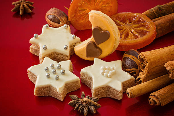 istock Christmas cookies, in different shapes, with spices, festive red background 501934218