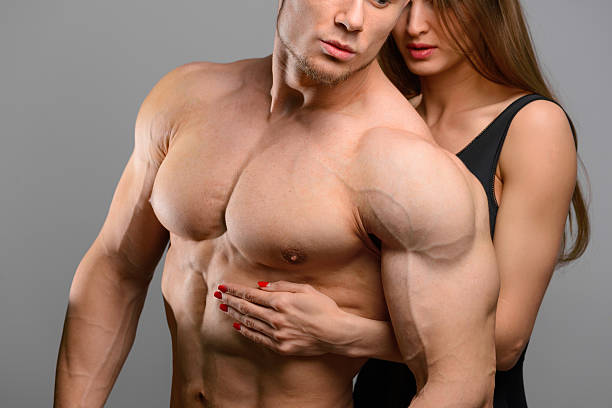istock Couple of athlete lovers without faces posing on grey background 501935726