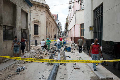 Havana, Cuba - December 17, 2014: A construction crew works on installing a new underground pipe in Habana Vieja, the historic old town of Havana, Cuba