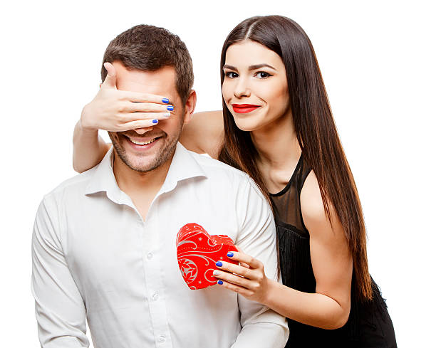 istock Young beautiful couple with present isolated on white 501936216