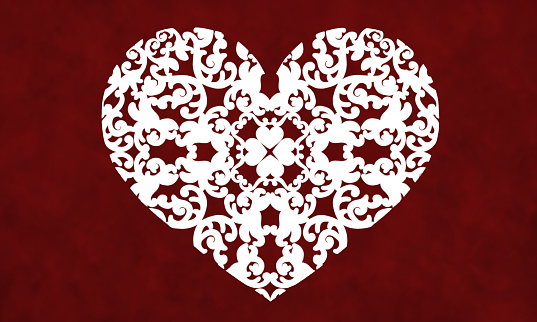 A white vintage cut-out heart pattern on a red textured background.
