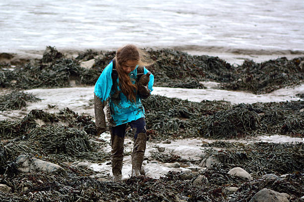 istock Child covered in mud on the seaside 501940654