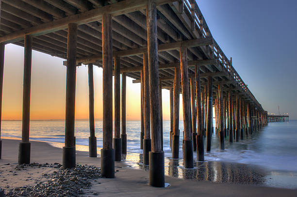 istock Glow of dawn through wooden pier 501944108
