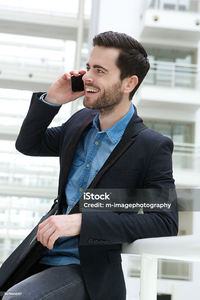 Cute guy on mobile phone indoors Portrait of a cute guy calling by mobile phone indoors 20-29 Years Stock Photo