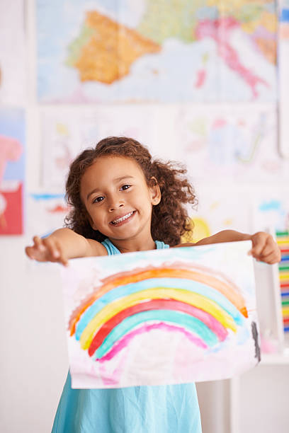 Proud of her rainbow masterpiece
