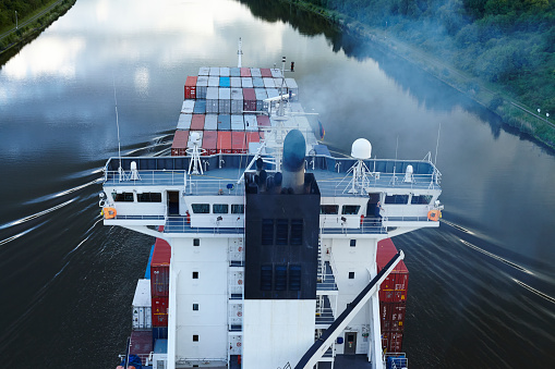 Beldorf, Germany - June 14, 2014: The exhaust fumes of the container vessel Calisto on the Kiel Canal near Beldorf (Schleswig-Holstein, Germany) taken in the early evening on June 14, 2014.