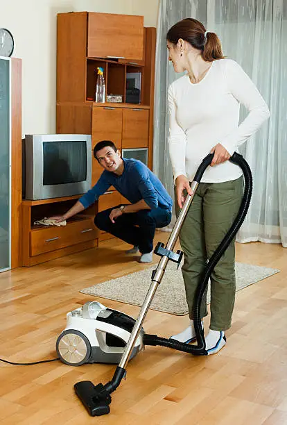 Ordinary family  couple doing housework together in home