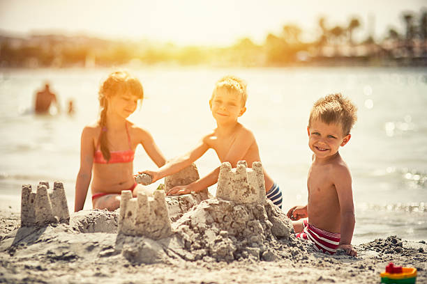 istock Kids building a sandcastle 501946560