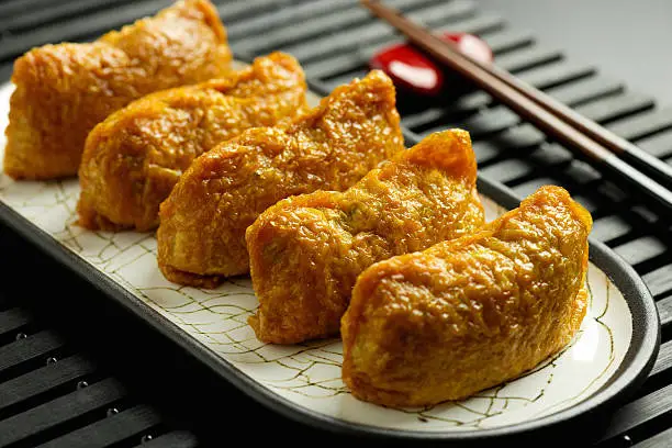 Japanese traditional type of sushi Inari-zushi, made from fried soy tofu wrapper and filled with sushi rice