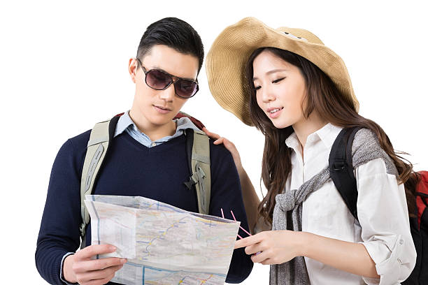 istock Young Asian couple travelers looking the map 501947011