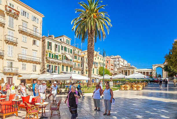 Famous cafes at building at Kapodistriou street Kerkyra, Corfu, Greece - September 24, 2013:: Famous cafes at building at Kapodistriou street with lot of tourists. This street located near platia Enoseos at old city. corfu holiday palace stock pictures, royalty-free photos & images