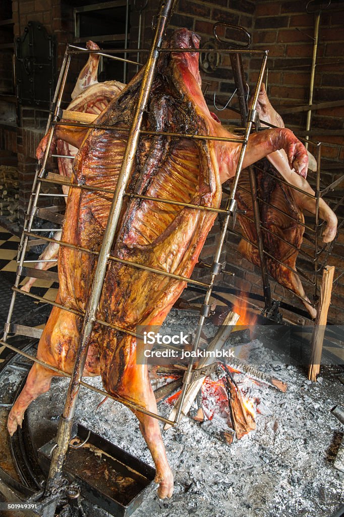 Pig roasting on wood fire Famous Bali delicacy named 'Babi Guling' during which the pig is slowly cooked. Asia Stock Photo