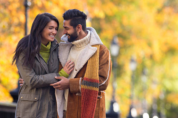 Young Couple Outdoors Young mixed race couple outdoors in autumn. indian man walking in park stock pictures, royalty-free photos & images