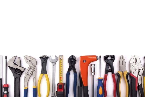 Work tools lined up in a straight line on white background.