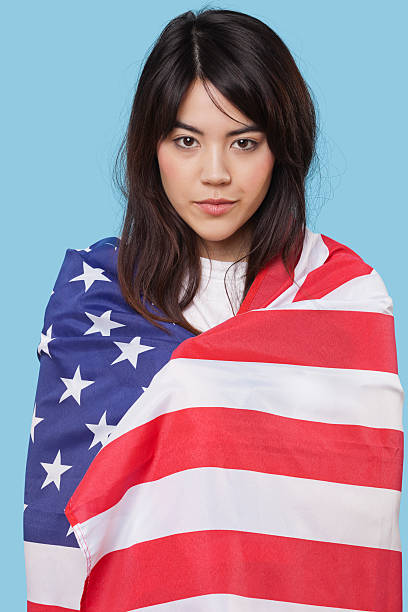 Patriotic young woman wrapped in flag