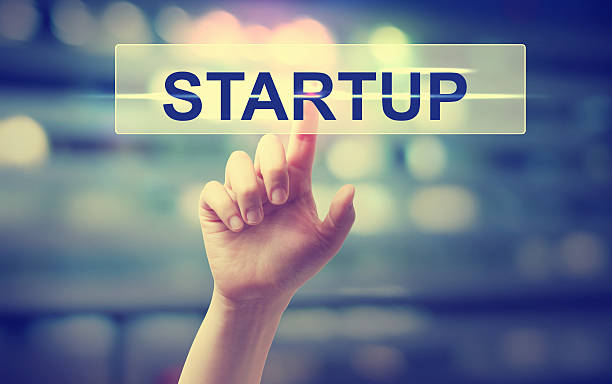 istock Hand pressing a startup button on blury city lights background 501963530