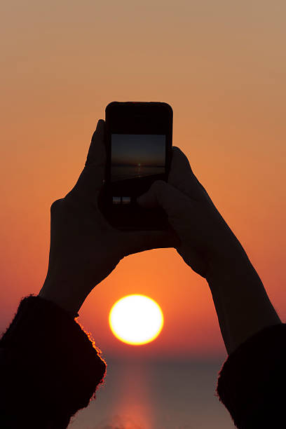 istock Taking sunset photos with a mobile phone 501963672
