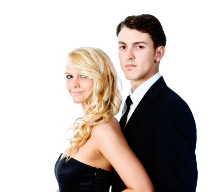 A good looking young couple pose for a half-length Prom night portrait or engagement photo.