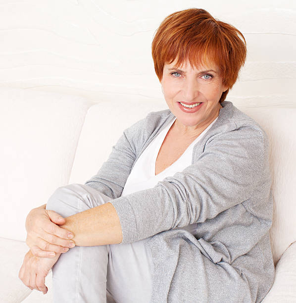 istock Happy mature woman on sofa 501964887