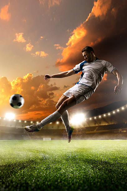 istock Soccer player in action on sunset stadium background 501965232
