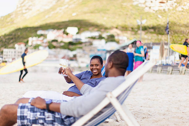 istock African couple drinking champagne on the beach 501965245