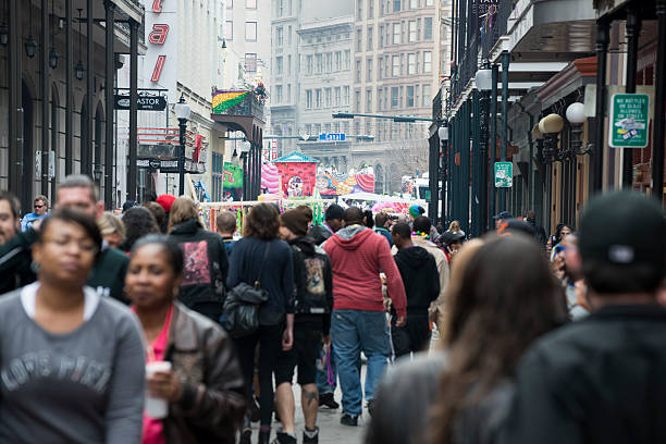 New Orleans, Louisiana, USA - February 9, 2013: A crowd of people walk on Bourbon Street in New Orleans' historic French Quarter.