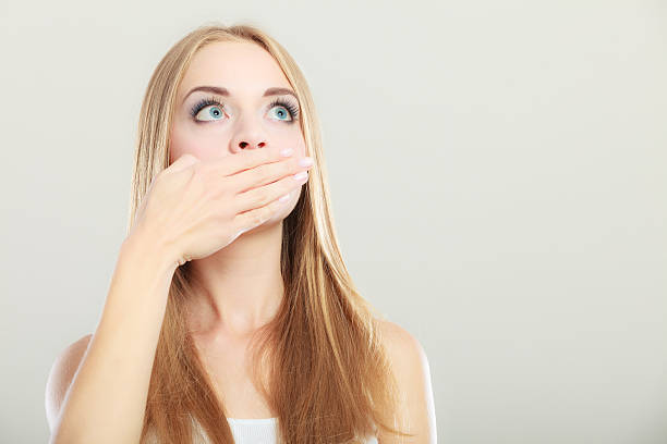 istock Amazed woman covering her mouth with hand 501968266