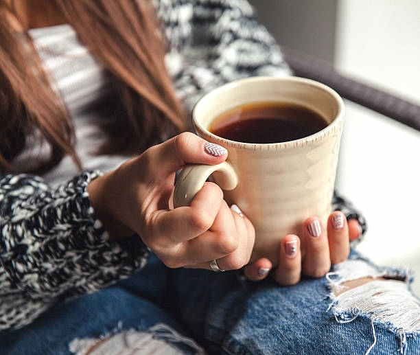 istock Girl's hands holding cup of coffee 501969644