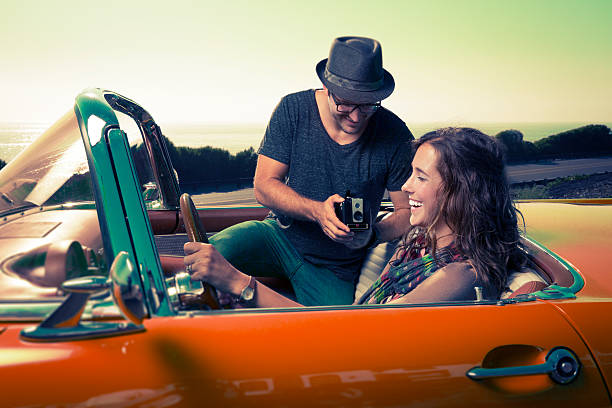 istock Couple Taking a photo with  a Antique camera in a Convertible 501970870