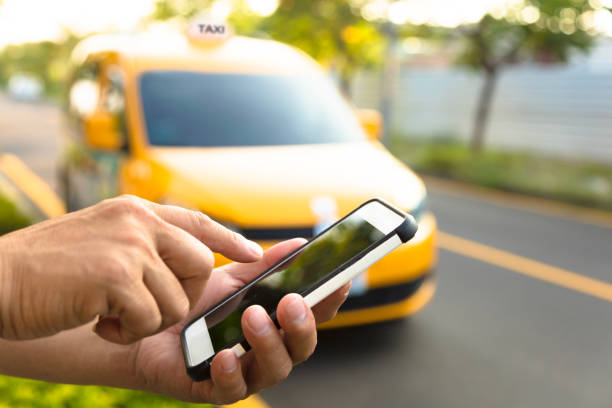 istock Man orders a taxi from his cell phone 501973952