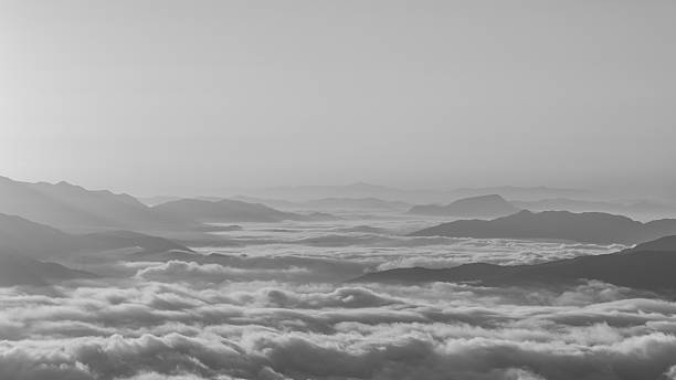 istock fog and cloud mountain valley landscape in black and white. 501974792