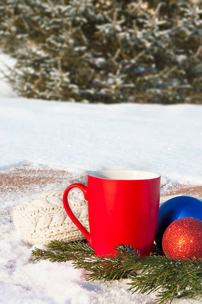 istock red mug with Christmas balls in the winter forest 501975586