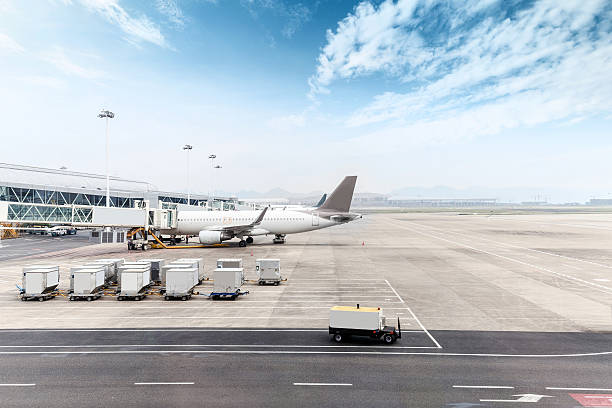istock cloudy skyline and airplane on airport ramp 501977258