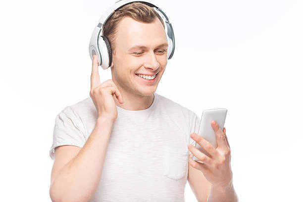 istock Handsome man with headphones and smartphone 501977300