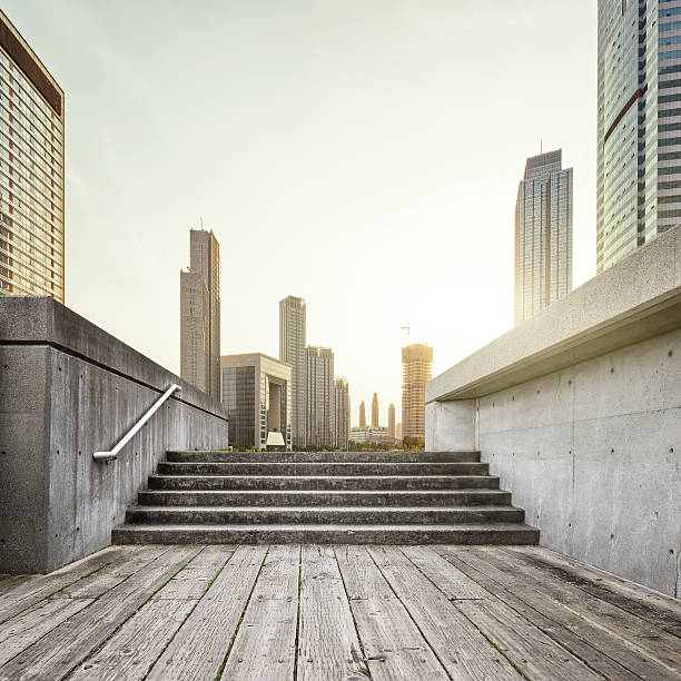 istock sun skyline and wooden floor front buildings 501977388
