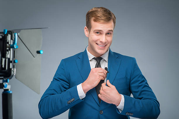 istock Smiling newsman adjusting the microphone 501977898