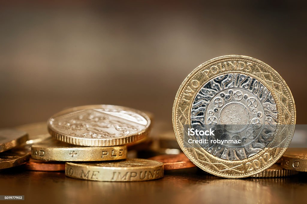 British Coins British coins over blurred background.  One and two pound coins. Coin Stock Photo