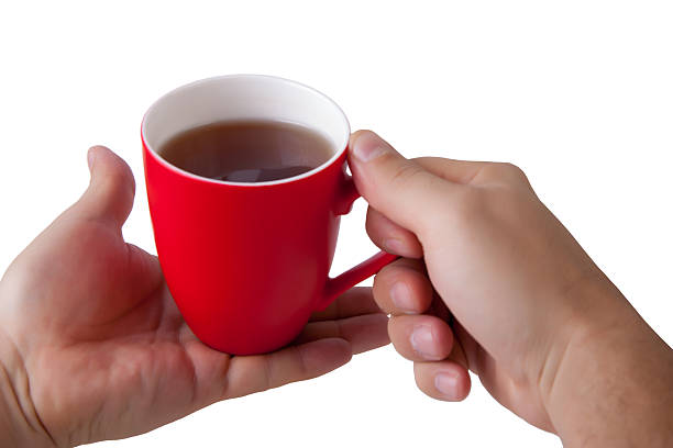 Hand hold red mug.