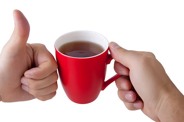 Hand hold red mug.