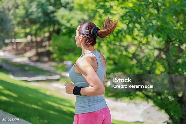 Beautiful Young Woman Running In Park Pathway Stock Photo - Download Image Now - Active Lifestyle, Activity, Adult